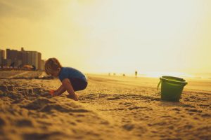 kid-building-sand-castle-on-the-beach-by-jeremy-mcknight-at-unsplash