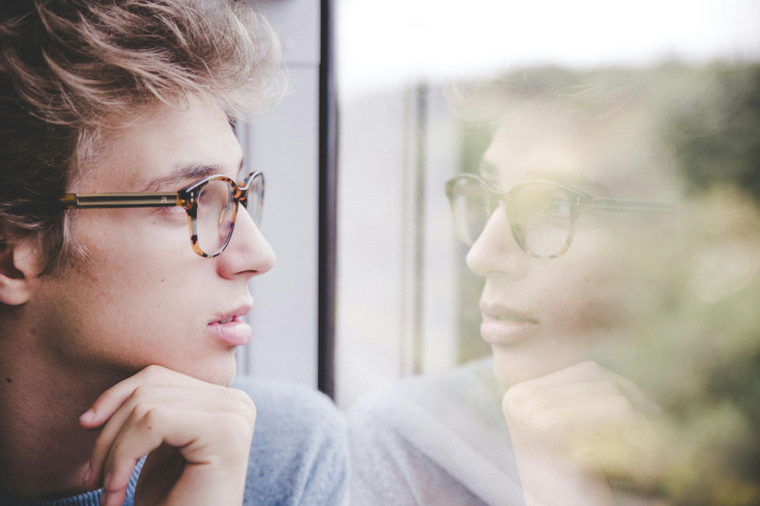 man-wearing-glasses-looking-out-the-window-bylaurenz-kleinheider-at-unsplash