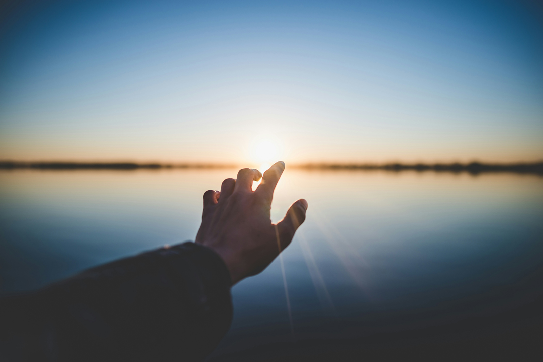 person-and-reaching-out-towards-sun-by-marc-olivier-jodoin-at-unsplash