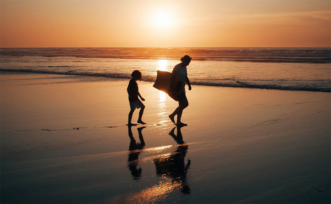 mom-and-child-walking-on-the-sunset-beach-by-tim-hufner-at-unsplash